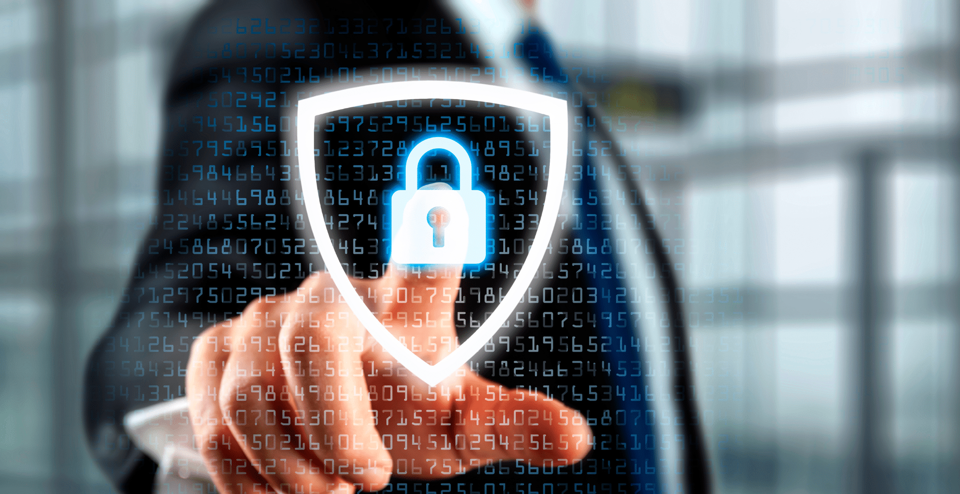 a glowing shield symbol with a padlock inside is being pressed by a person dressed in a suit